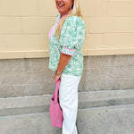 Green floral print caftan-style top with puff sleeves, split neckline, and lightweight fabric for effortless style.