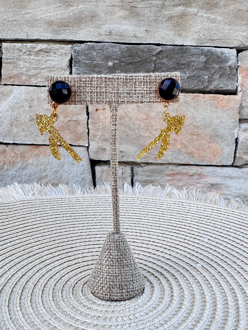 Burgundy round gemstone stud earrings with sparkling gold spear-shaped dangling accents.
