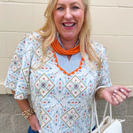 Printed puff sleeve top with striped neckline and orange trim