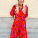 Pink, orange, and brown floral midi dress with v-neckline, tiered skirt, and ¾ puff sleeves.