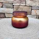 Apple Oud Tuscan Radiance petite scented candle in a decorative vessel.
