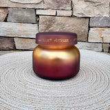 Apple Oud Tuscan Radiance petite scented candle in a decorative vessel.