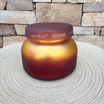 Apple Oud Tuscan Radiance scented candle in an elegant decorative vessel.