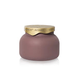 Matte mauve glass candle with sculpted brushed-gold tile-inspired lid