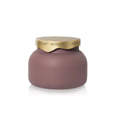 Matte mauve glass candle with sculpted brushed-gold tile-inspired lid