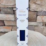 Navy blue Volcano scented reed diffuser with gold accents.