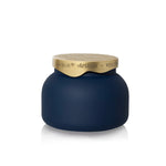 Matte midnight glass candle with sculpted brushed-gold architectural lid