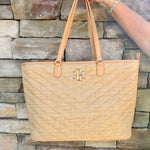 Natural oversized V-quilted straw tote with vegan leather trim, zipper closure, and multiple interior pockets