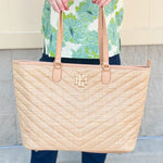 Natural oversized V-quilted straw tote with vegan leather trim, zipper closure, and multiple interior pockets