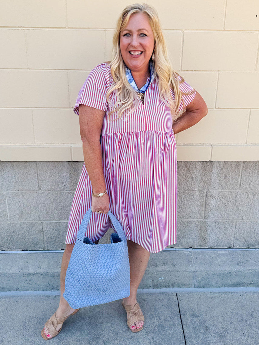 Red and white striped babydoll mini dress with V-neckline and short drop sleeves, styled for playful summer days.
