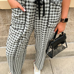 Black and white checkered pants with an elastic tie waistband and front pockets.
