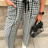 Black and white checkered pants with an elastic tie waistband and front pockets.
