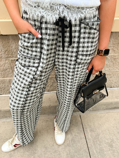 Black and white checkered pants with an elastic tie waistband and front pockets.