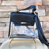 Clearly Handbags Susan clear square crossbody bag with black leather accents, gold hardware, and long strap.