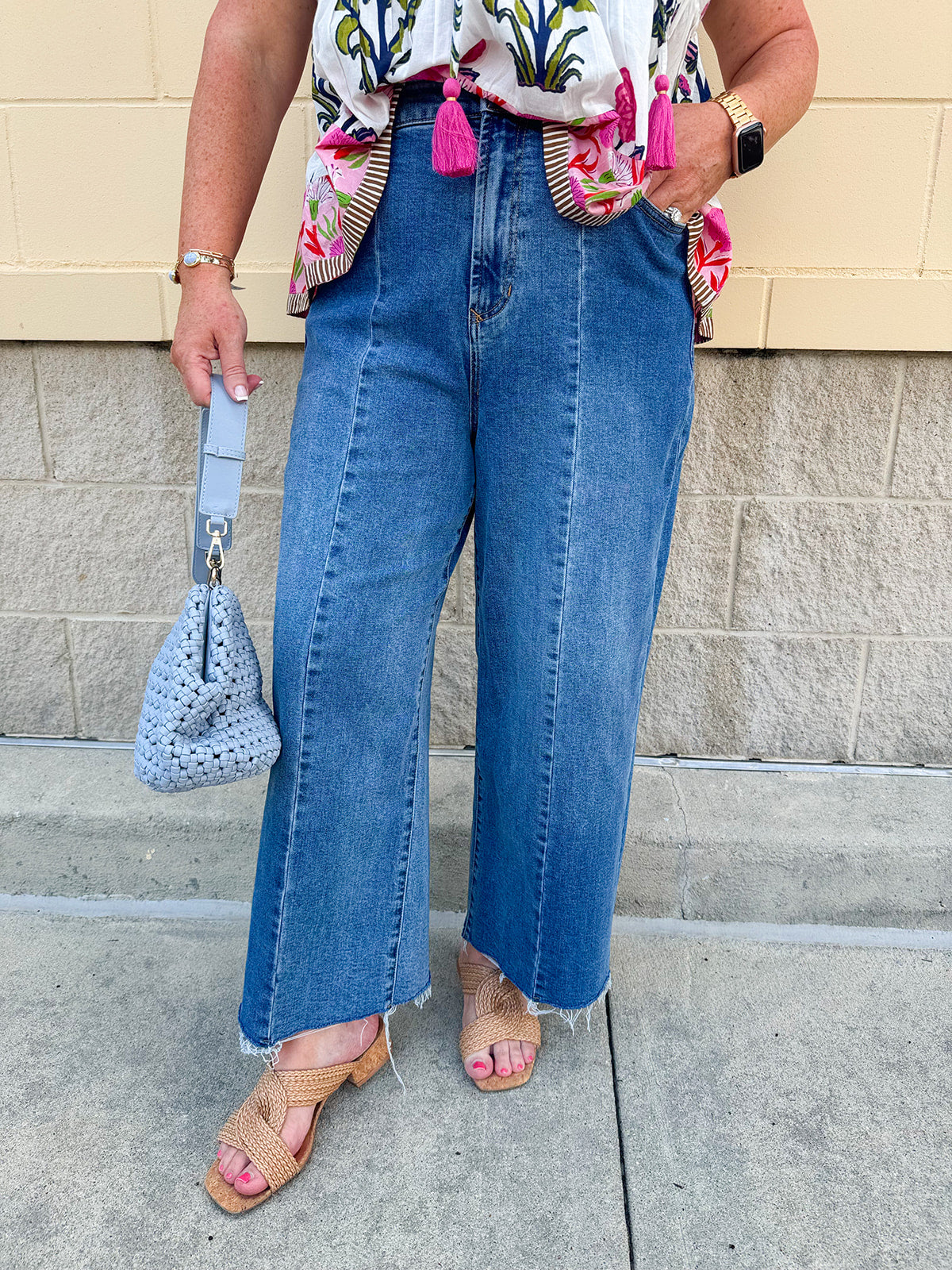 Medium wash wide leg jeans with mid rise, front seam, and front slits for a flattering, modern fit.