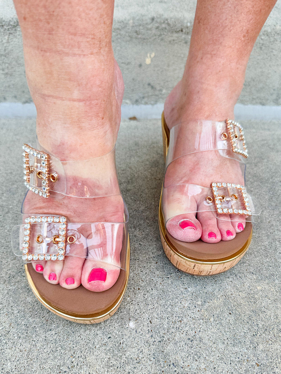  Clear rhinestone buckle wedge sandals with a neutral sole, offering stylish sparkle and all-day comfort.