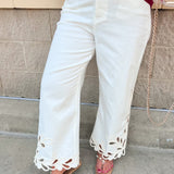 White high-rise cropped wide-leg jeans with scalloped hem and embroidered detailing.