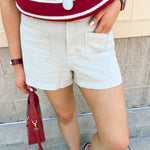 Stone high rise woven shorts with front patch pockets, clean hem, and structured silhouette.
