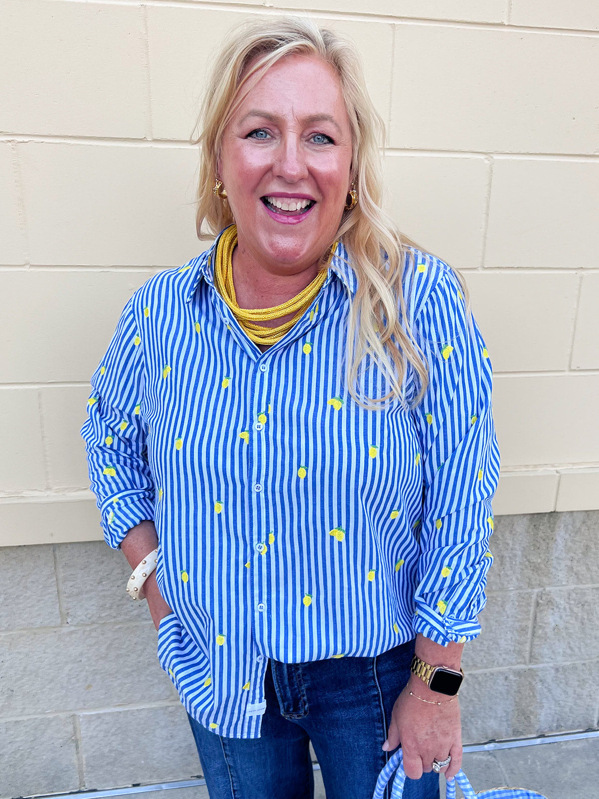 Blue and white striped button-down blouse featuring small yellow lemon graphics, collared neckline, long sleeves, and a relaxed fit.