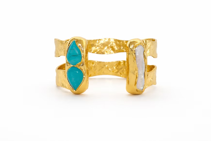 Adjustable double-plated cuff bracelet featuring turquoise stones and freshwater pearl accents