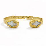 Adjustable 18K gold-plated cuff bracelet featuring luminous pearl and cross-inspired accents