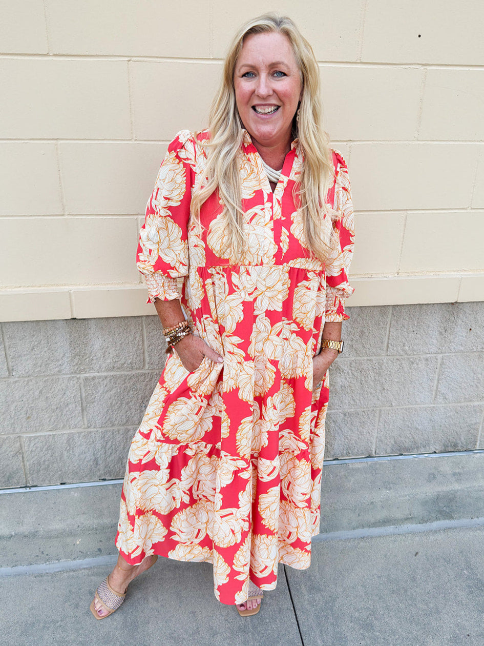 Pink, tan, and cream floral midi dress with point collar, smocked cuff sleeves, and pockets.