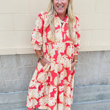 Pink, tan, and cream floral midi dress with point collar, smocked cuff sleeves, and pockets.