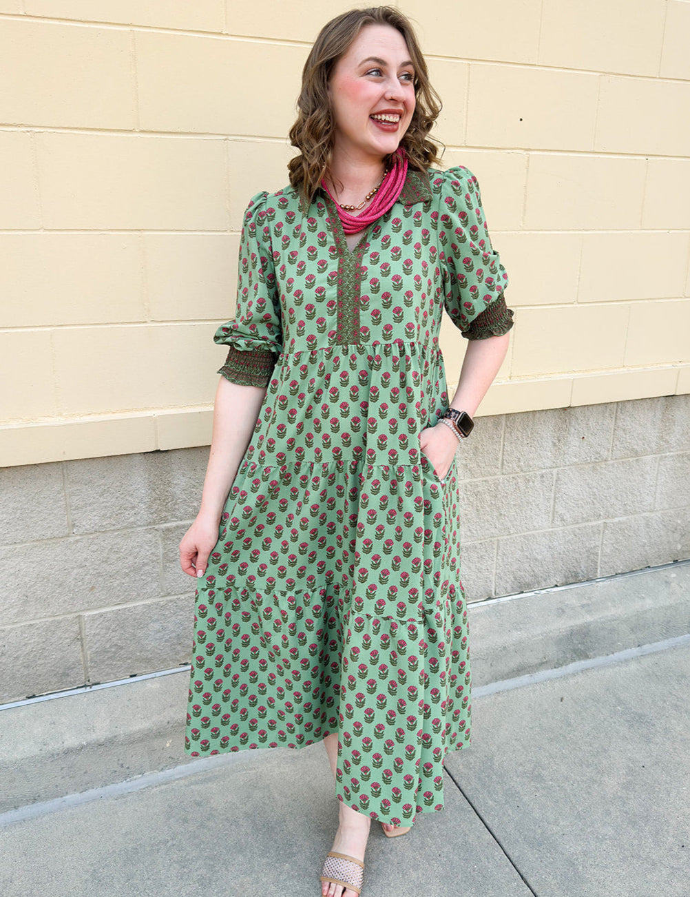 Pink and green floral midi dress with point collar, smocked sleeves, and pockets.