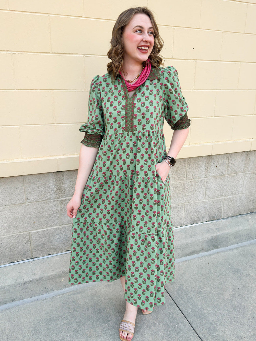 Pink and green floral midi dress with point collar, smocked sleeves, and pockets.
