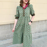 Pink and green floral midi dress with point collar, smocked sleeves, and pockets.