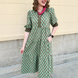 Pink and green floral midi dress with point collar, smocked sleeves, and pockets.