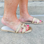 Ena Raffia H-Cutout Slides featuring a breathable raffia strap and modern H-cutout design, styled to showcase their chic, casual summer look and cushioned footbed