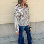Taupe brown and cream striped long sleeve blouse with collared neckline and cinched waist