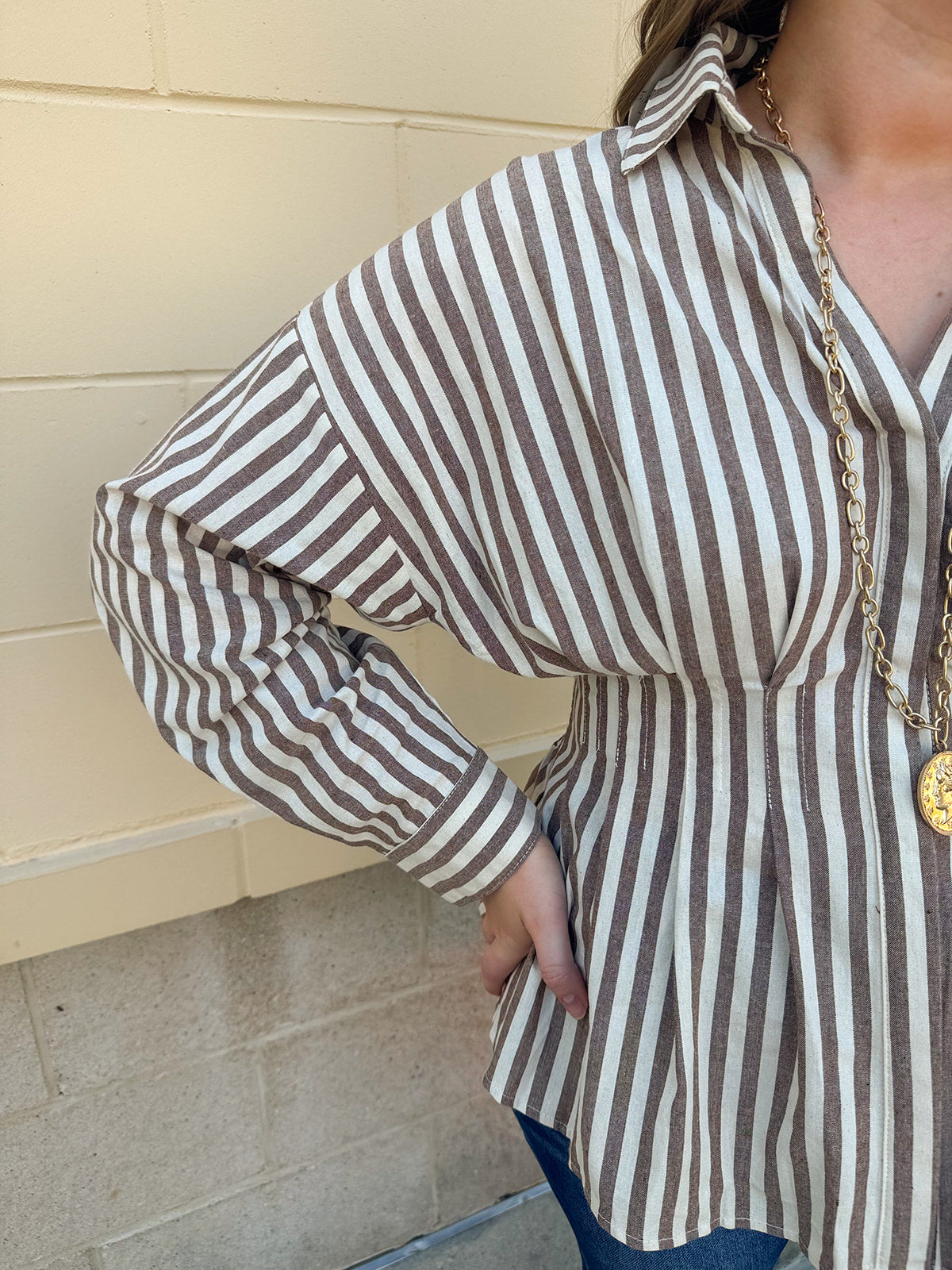 Taupe brown and cream striped long sleeve blouse with collared neckline and cinched waist