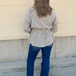 Taupe brown and cream striped long sleeve blouse with collared neckline and cinched waist
