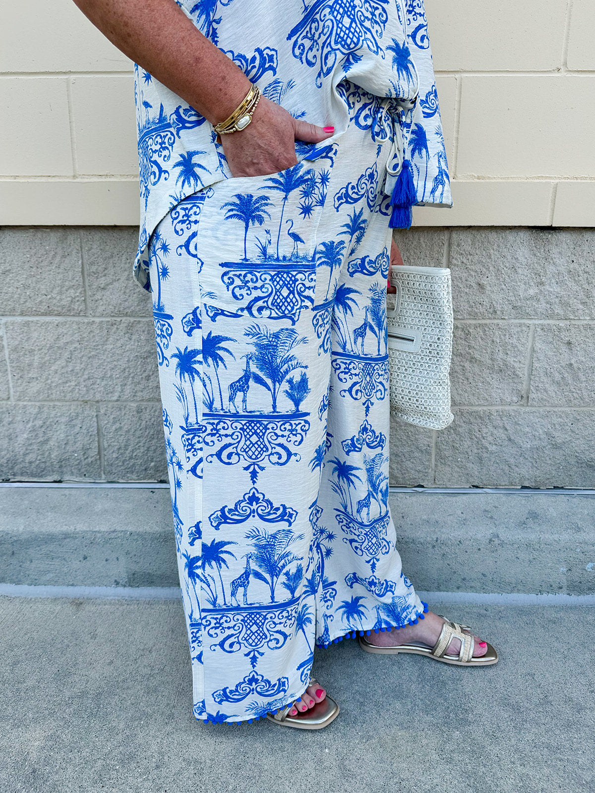 Crystal wearing the Feeling Chic Tassel Tie and Pom Pom Trim Pants – relaxed fit pants with a tassel drawstring waist and playful pom-pom trim, styled for a fun and effortless daytime look