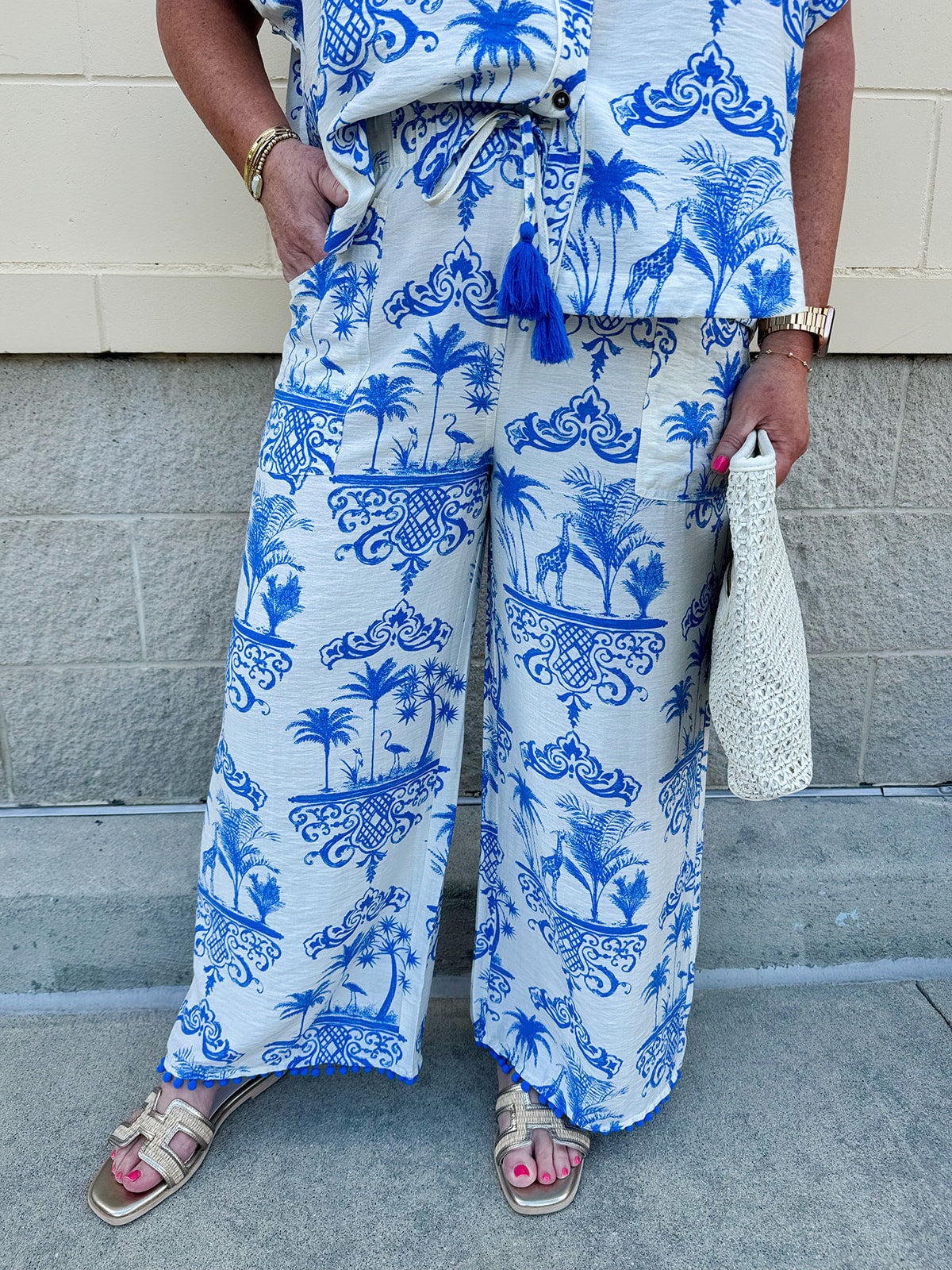 Crystal wearing the Feeling Chic Tassel Tie and Pom Pom Trim Pants – relaxed fit pants with a tassel drawstring waist and playful pom-pom trim, styled for a fun and effortless daytime look
