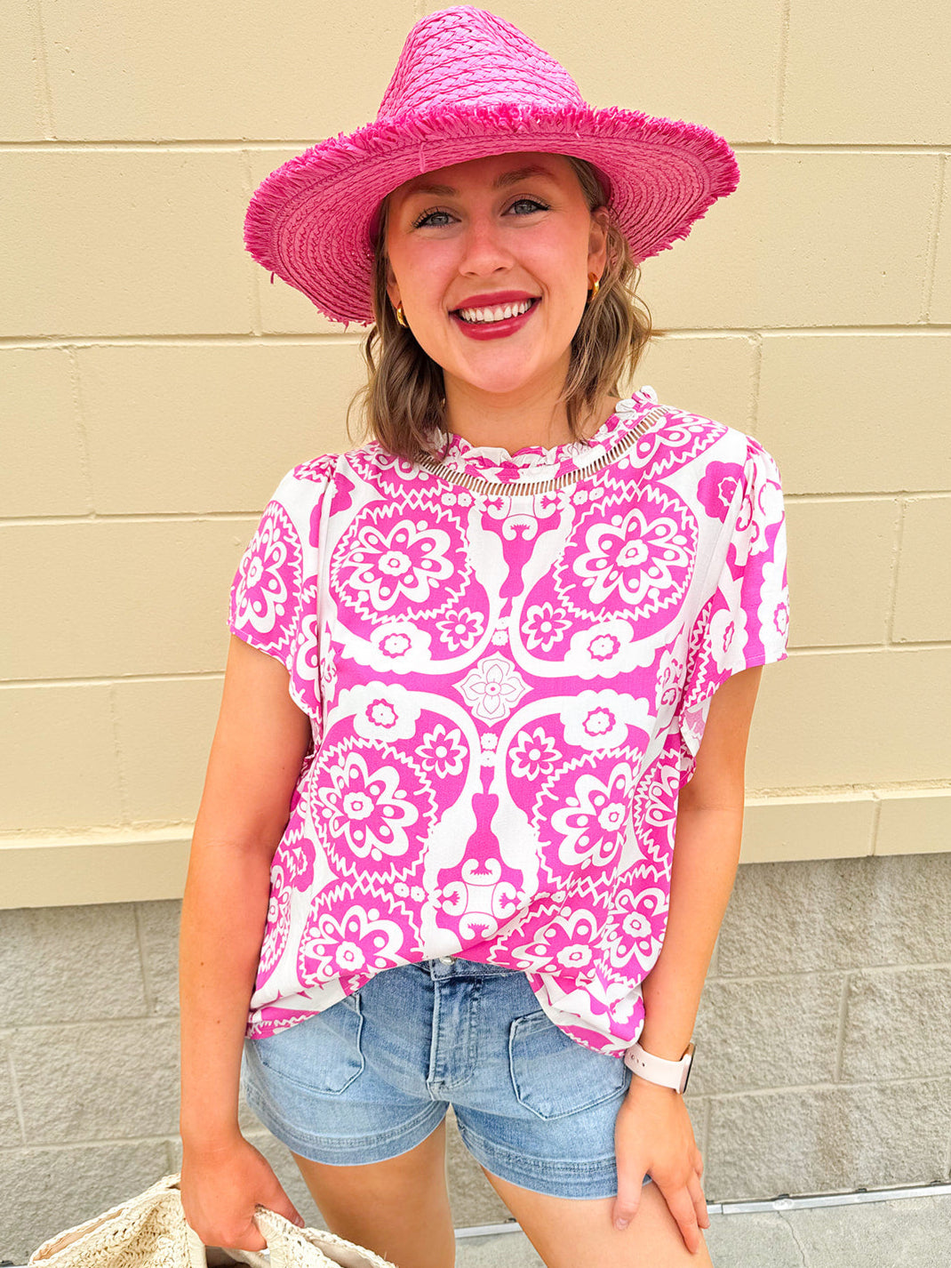 Pink and white blouse with lace-trim neckline and batwing sleeves, styled for a soft, feminine look.