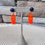 Florida Gators orange acrylic "CHOMP" drop earrings with blue faceted studs and gold-tone hardware.