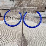 Royal blue hoop earrings featuring crystal "GATORS" lettering with gold-tone hardware.