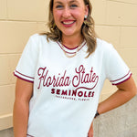 White short sleeve sweater knit top with garnet contrast piping at the neckline and sleeves featuring "Florida State" in cursive script with "Seminoles" and "Tallahassee, Florida" across the front.