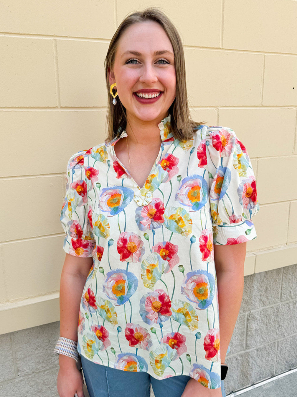 Lightweight floral blouse with puff sleeves and a pleated collar in soft cream with colorful floral print