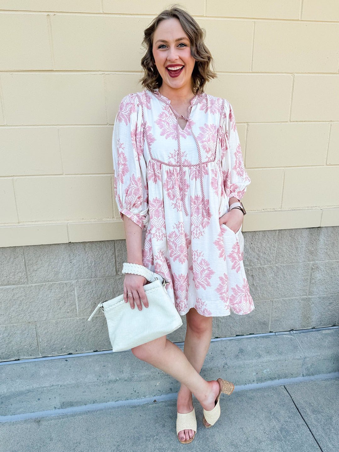 Garden Glance Tie Neck Mini Dress featuring a vibrant floral print, tie neck detail, and voluminous three-quarter sleeves with band cuffs – styled for a breezy, feminine daytime look.