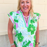 Green floral blouse featuring white, blue, and pink botanical prints with a lightweight, feminine silhouette.