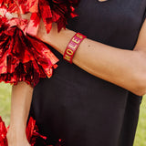 Garnet resin cuff bracelet with gold glitter NOLES lettering.