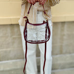 Clear crossbody stadium bag with garnet straps and gold hardware, perfect for stylish game day looks.