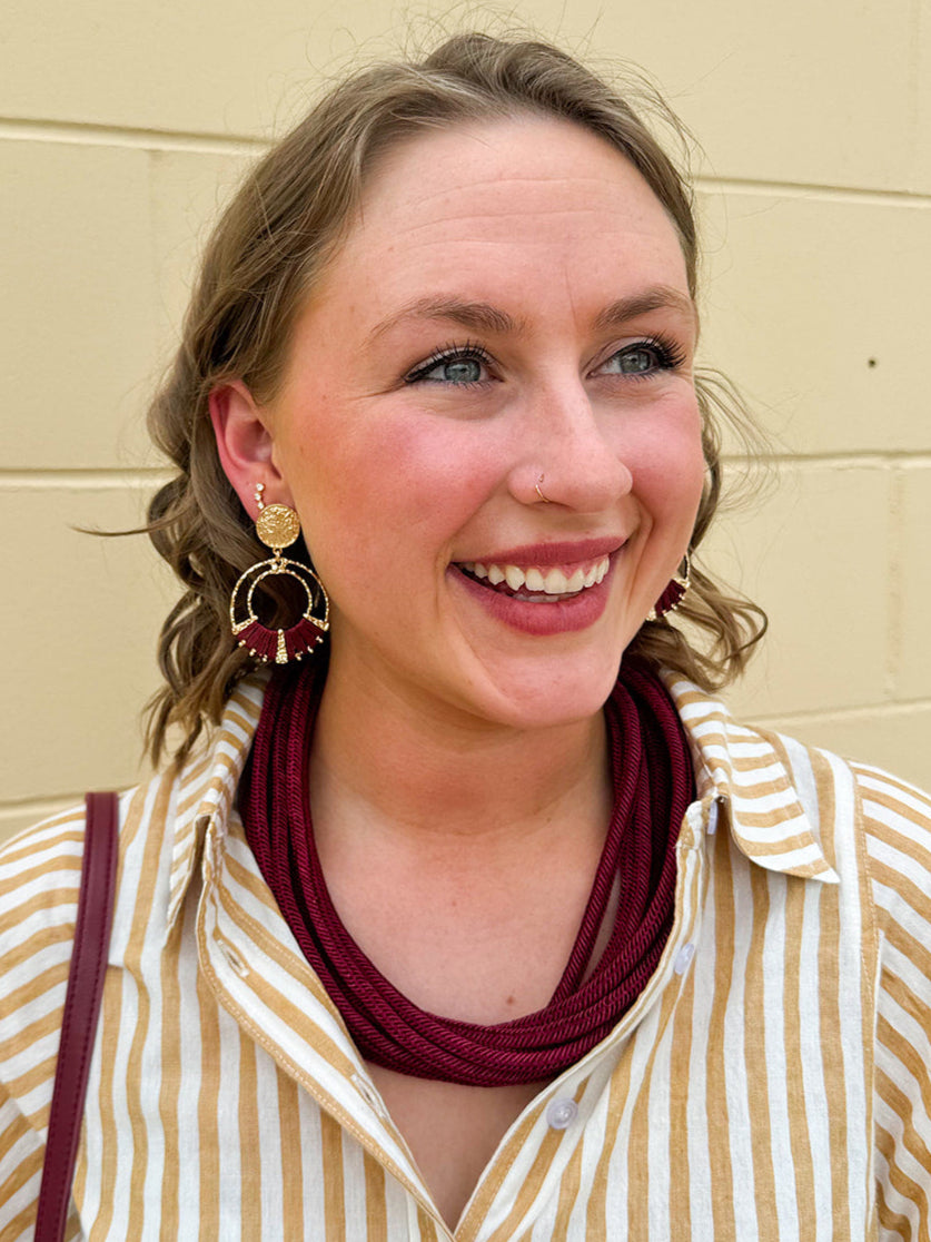 Gold double hoop earrings with garnet-threaded accents and gold stud top, perfect for adding subtle color and elegance.