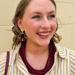 Gold double hoop earrings with garnet-threaded accents and gold stud top, perfect for adding subtle color and elegance.