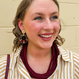 Gold double hoop earrings with garnet-threaded accents and gold stud top, perfect for adding subtle color and elegance.