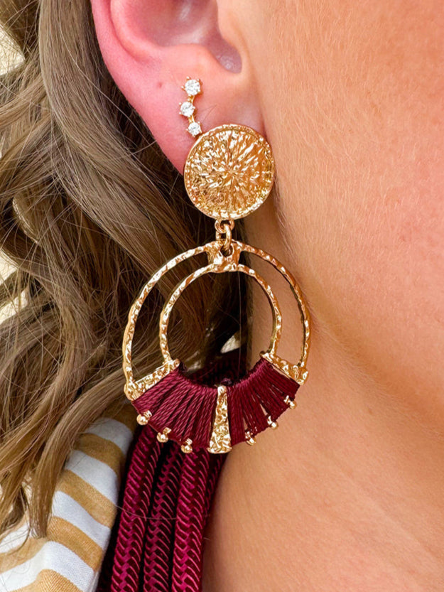 Gold double hoop earrings with garnet-threaded accents and gold stud top, perfect for adding subtle color and elegance.